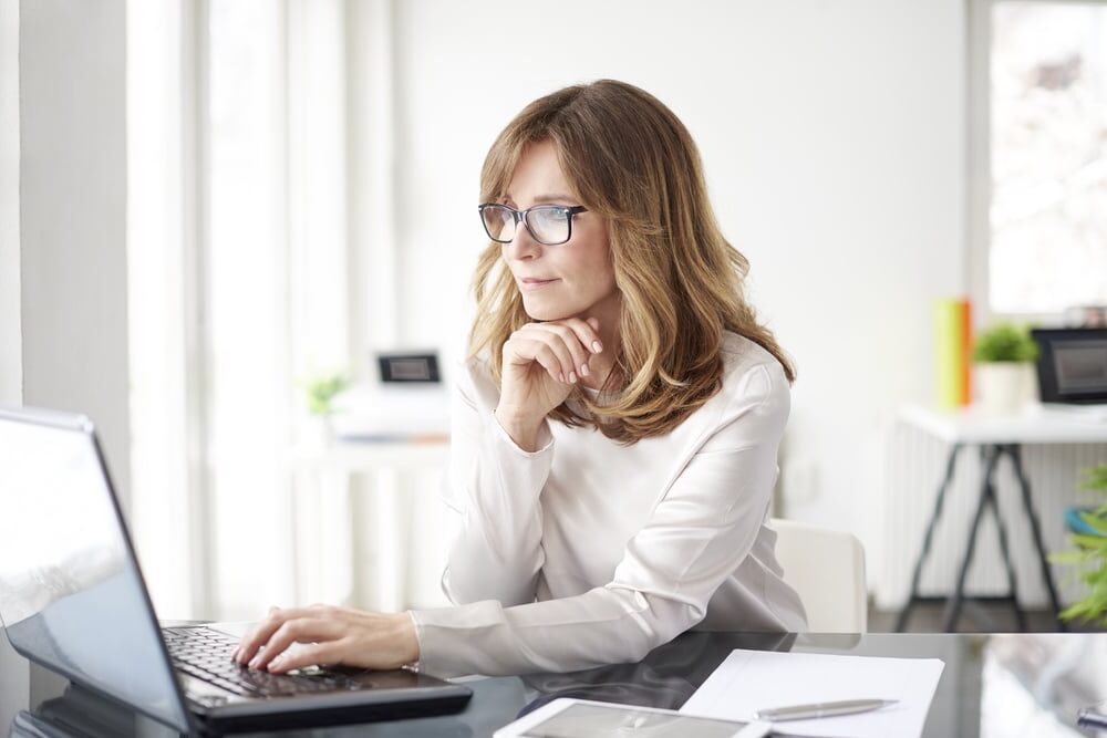 Shot,Of,An,Attractive,Mature,Businesswoman,Working,On,Laptop,In